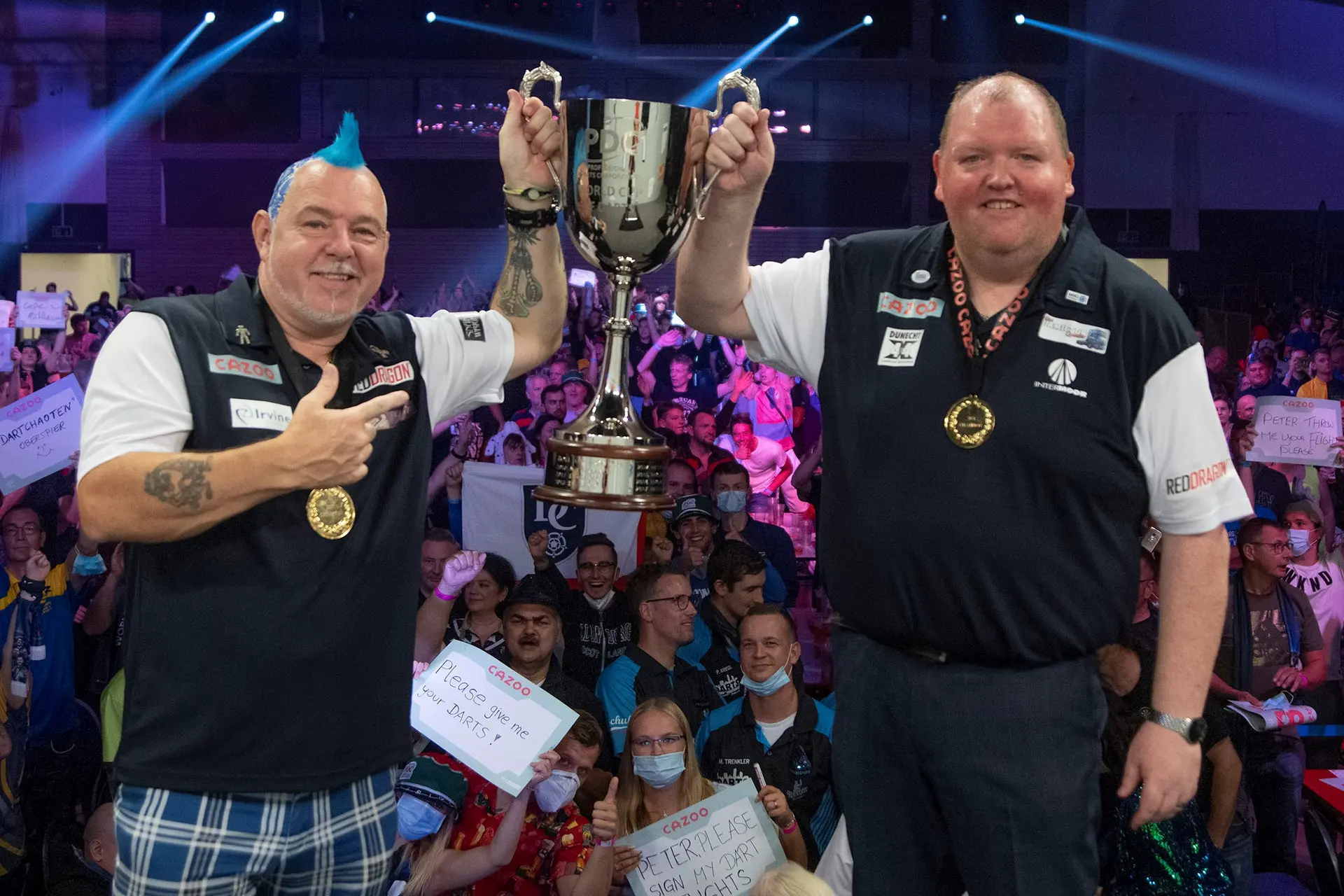 Peter Wright and John Henderson lift the World Cup trophy together.