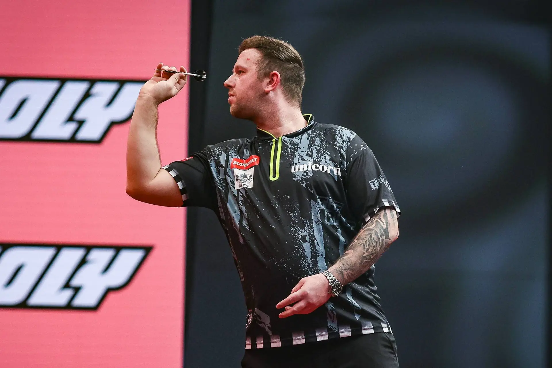 Callan Rydz throws a dart.