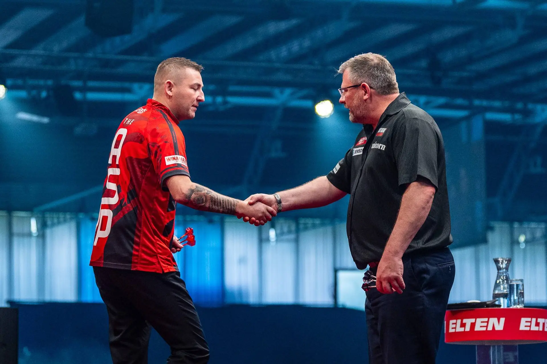Nathan Aspinall  &amp; James Wade shook hands.
