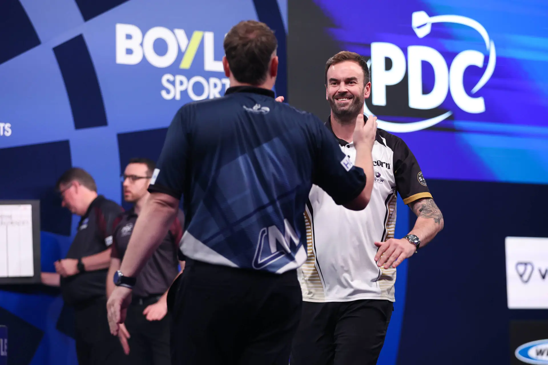 Ross Smith and Cameron Menzies shake hands ahead of their first round match at the 2026 World Grand Prix