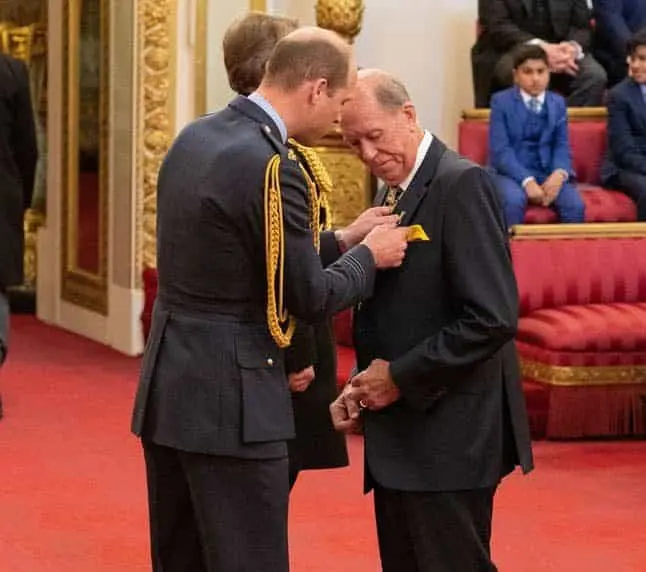 Lowe receives his MBE for services to darts and charity
