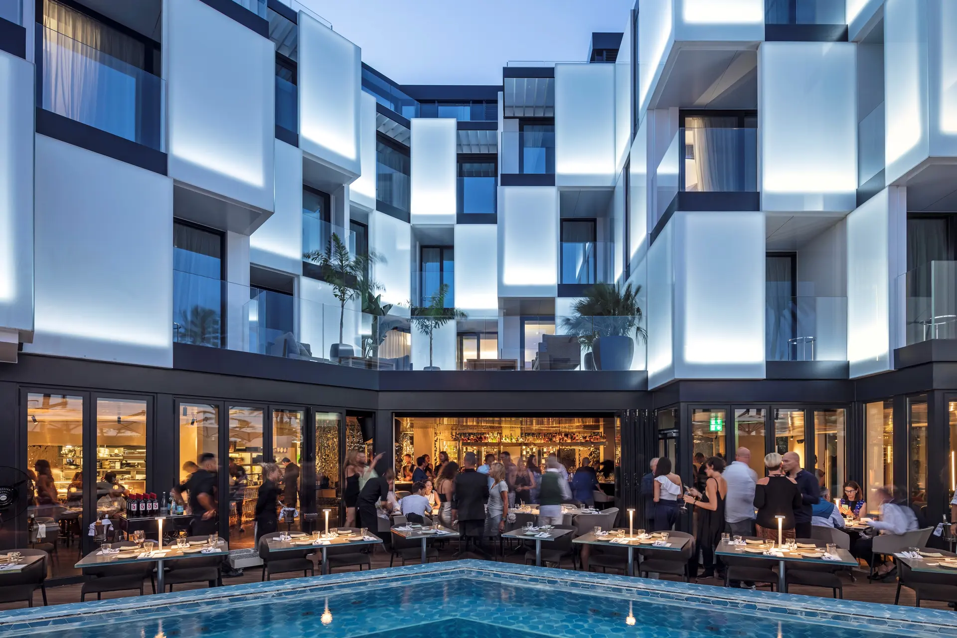 izakaya asian kitchen bar exterior and pool image credit amit geron crowd