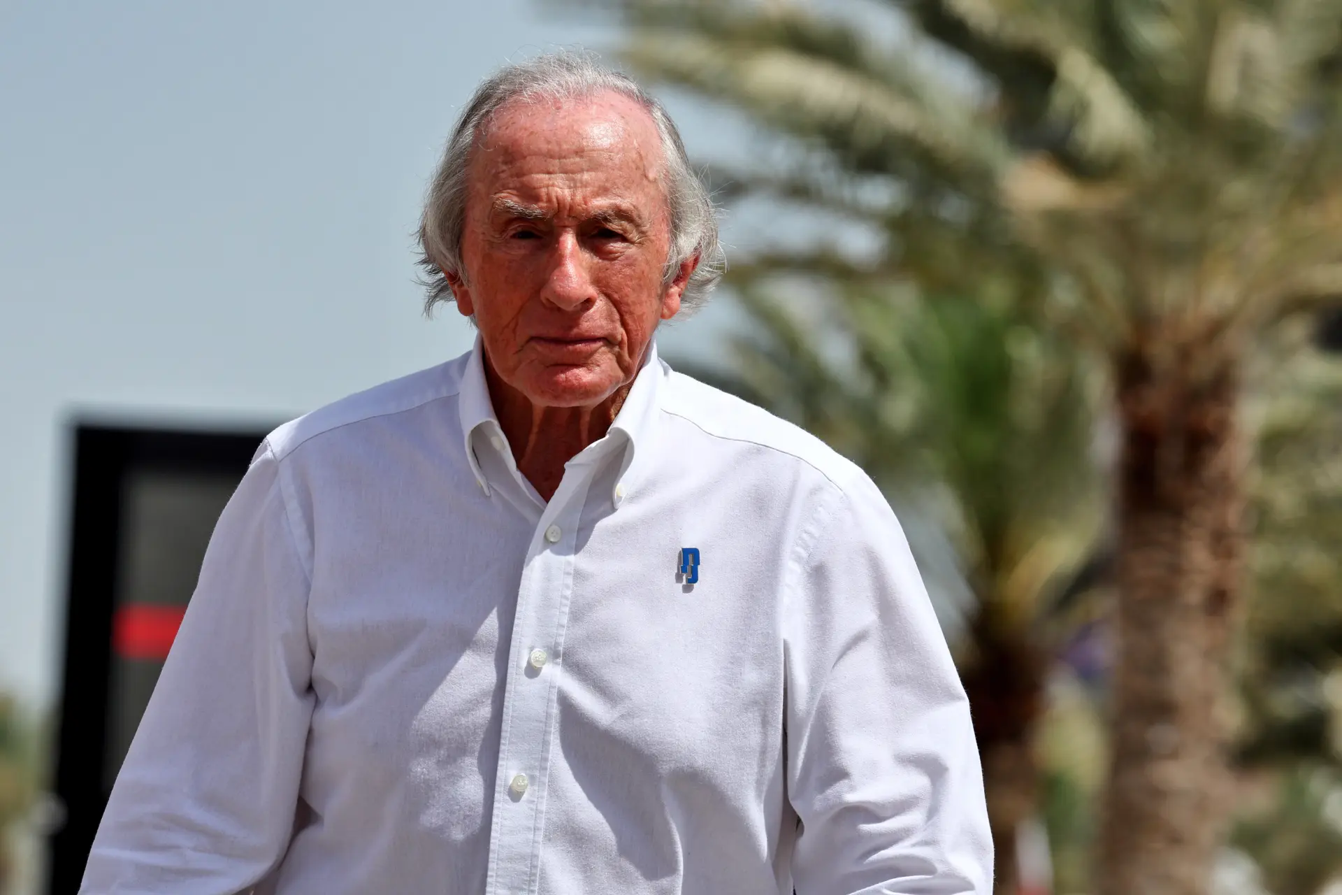 Michael Schumacher signs Jackie Stewart's Formula 1 helmet with help from his wife