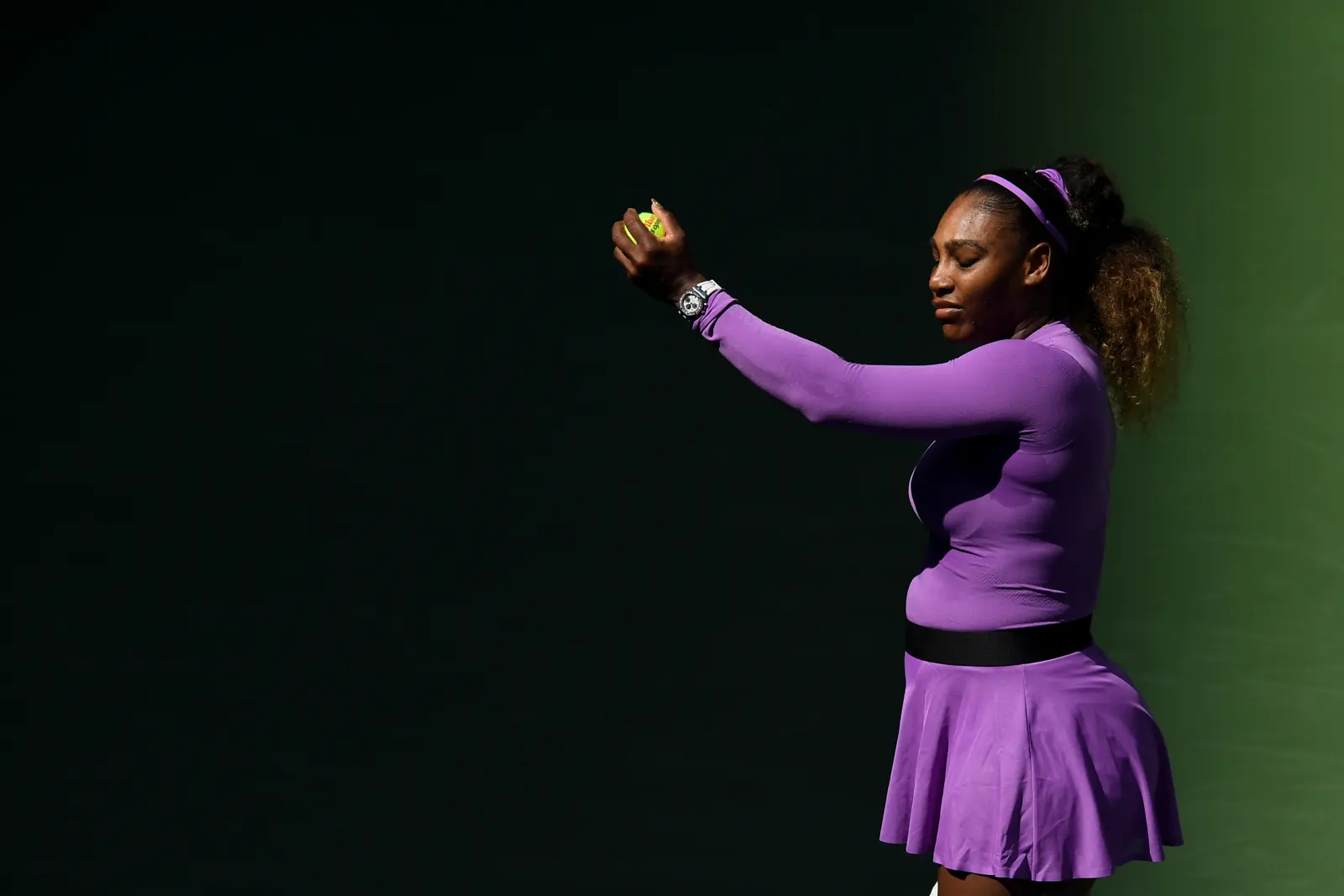 Why is Serena Williams playing with black plasters on her face?