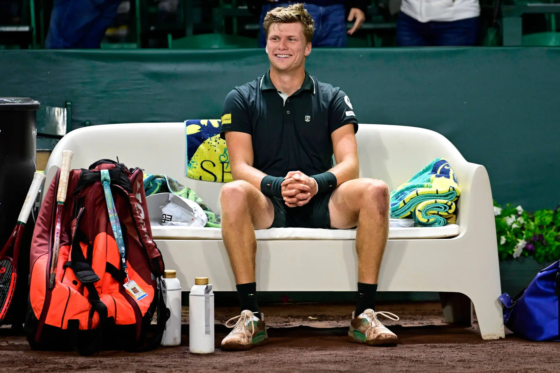 Jenson Brooksby sitting on the bench after winning the Houston Open title against Tiafoe