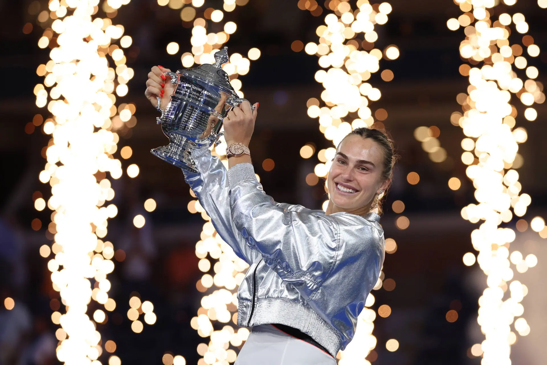 Sabalenka smiles with the 2025 US Open trophy after the awards ceremony