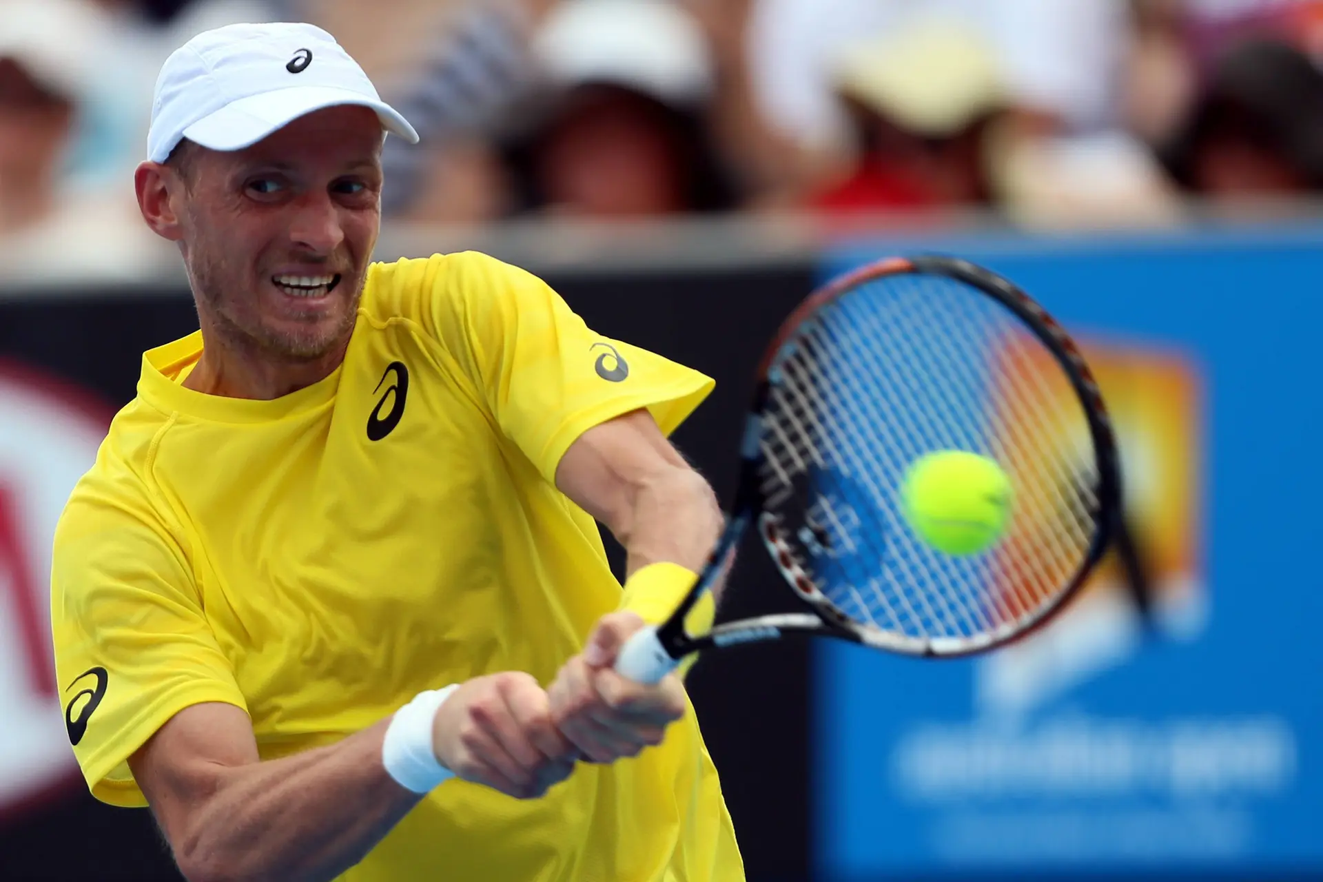 Nikolay Davydenko of Russia returns a shot in the men's singles first round match against Richard Gasquet of France at 2014 Australian Open