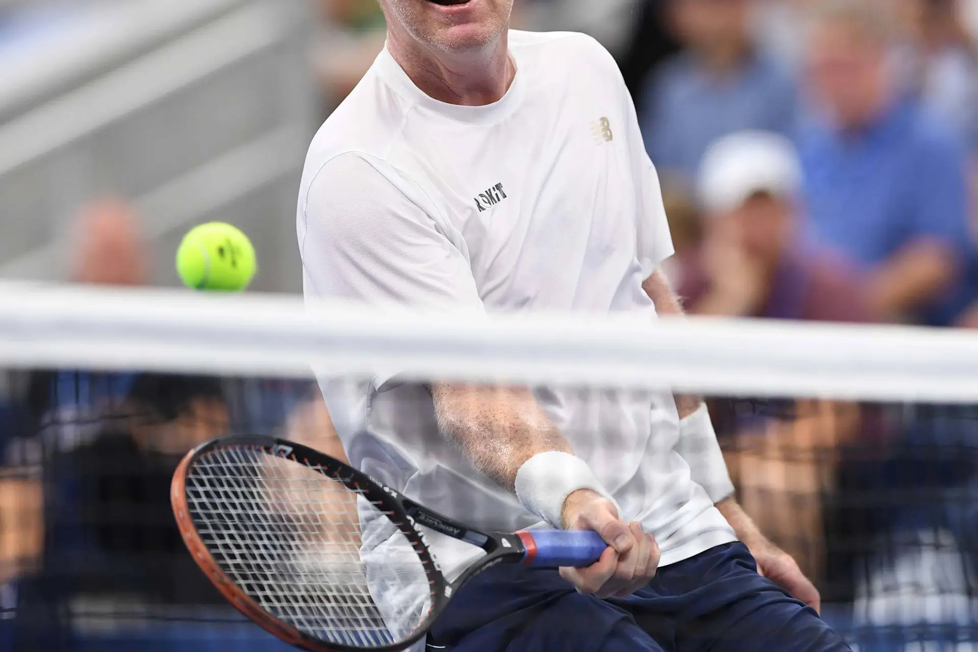 Jim Courier returns shot.