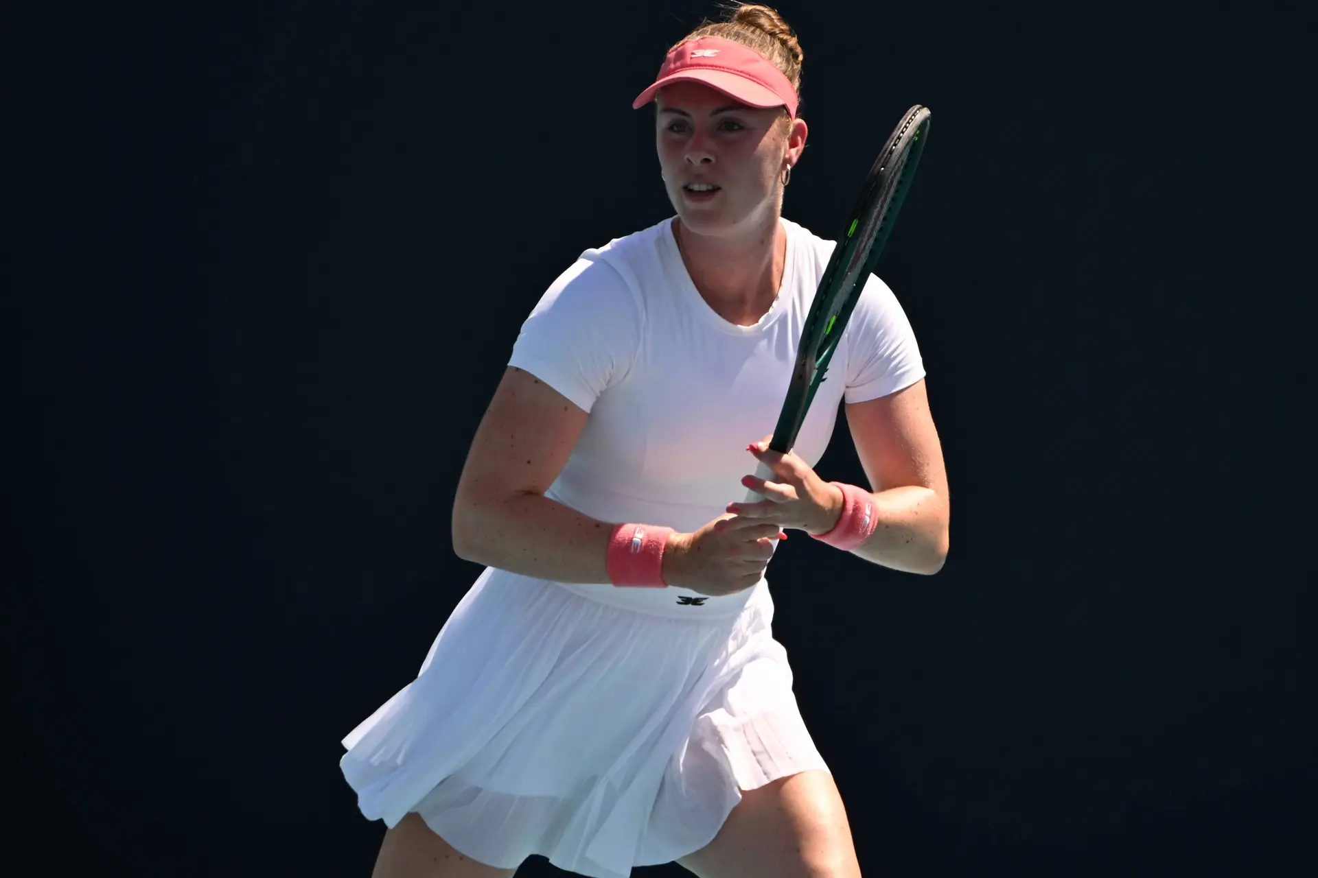 Talia Gibson readies racquet.
