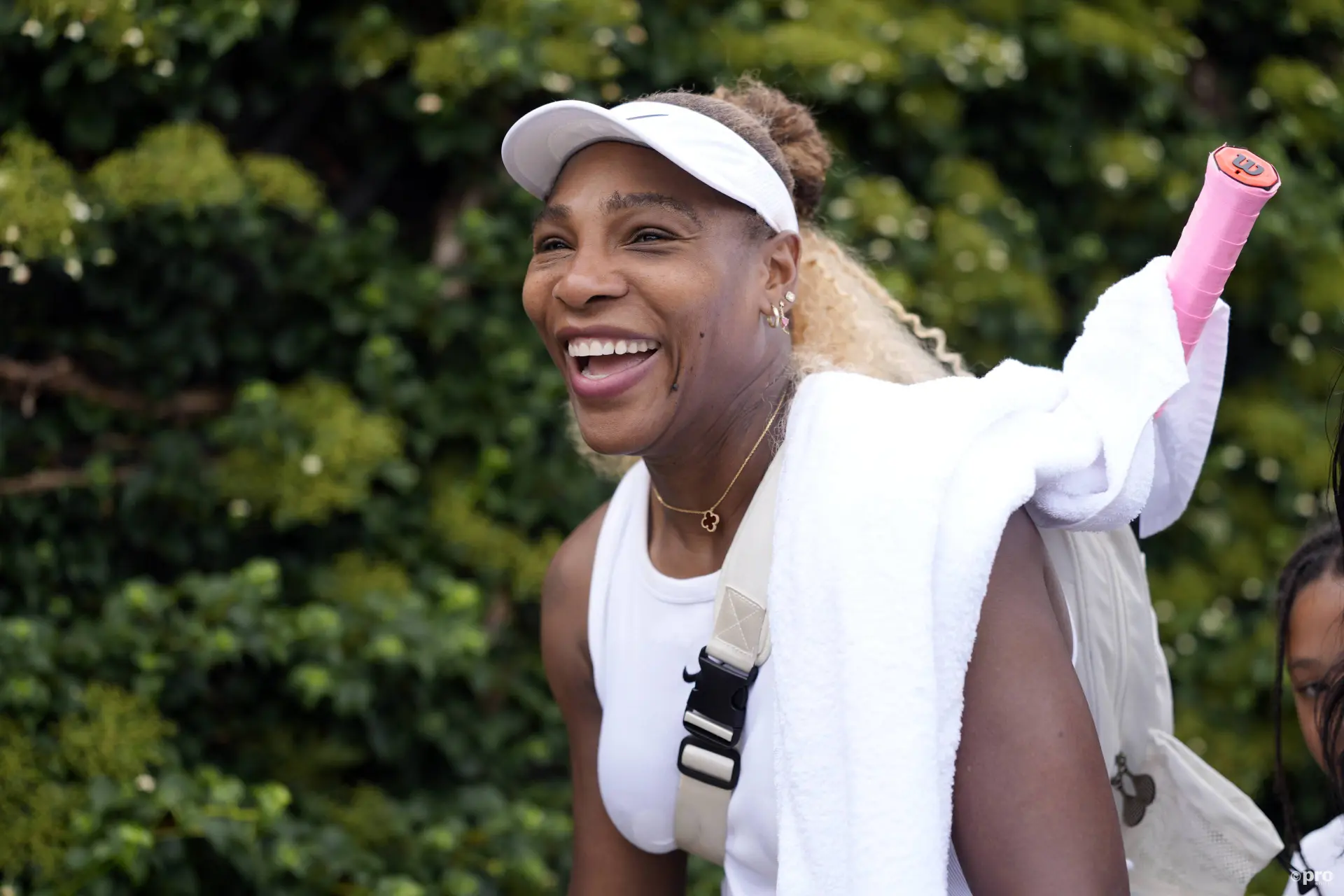 Serena Williams smiles walking back from practice.