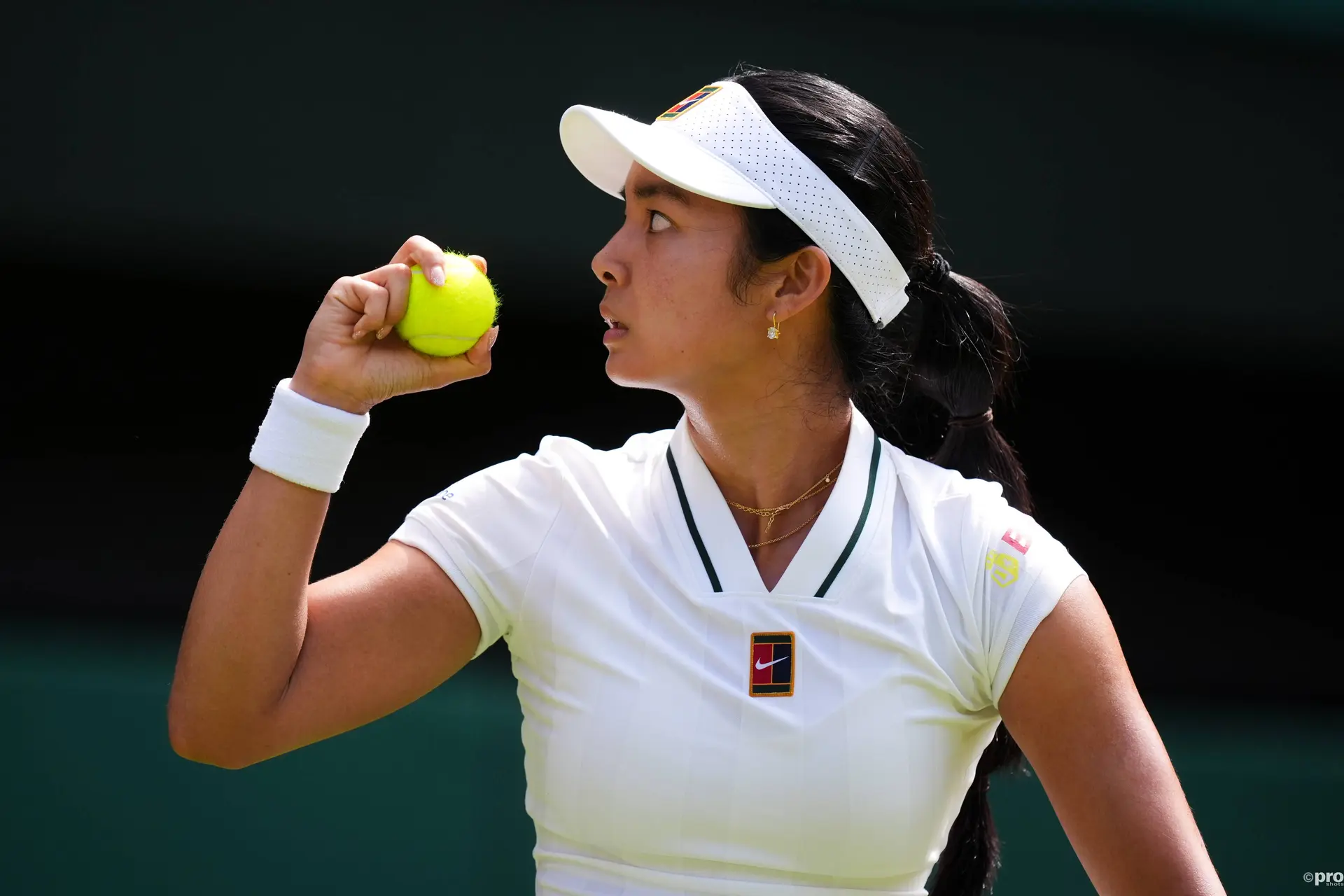 Alexandra Eala holds ball.