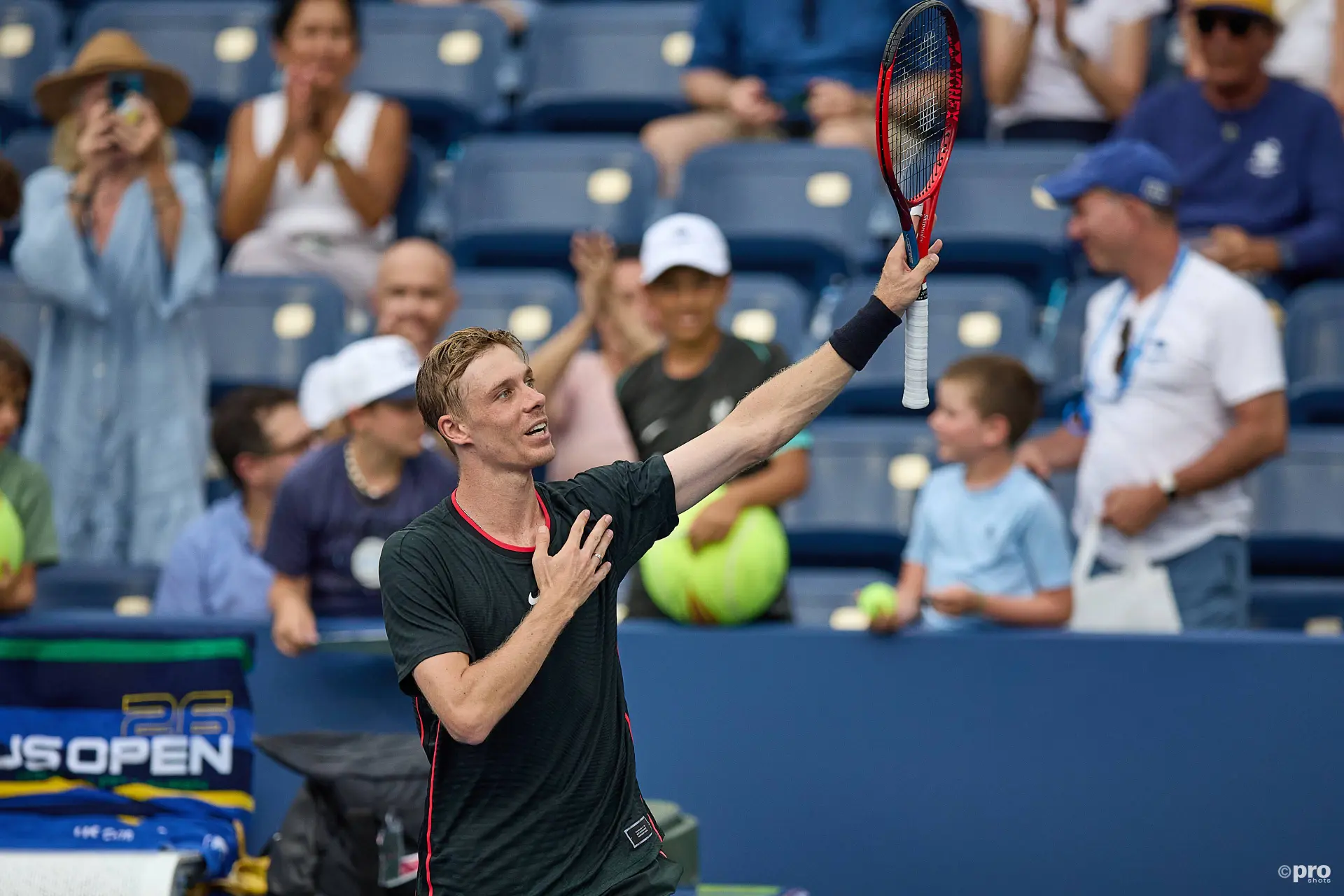 Denis Shapovalov holding his racket up