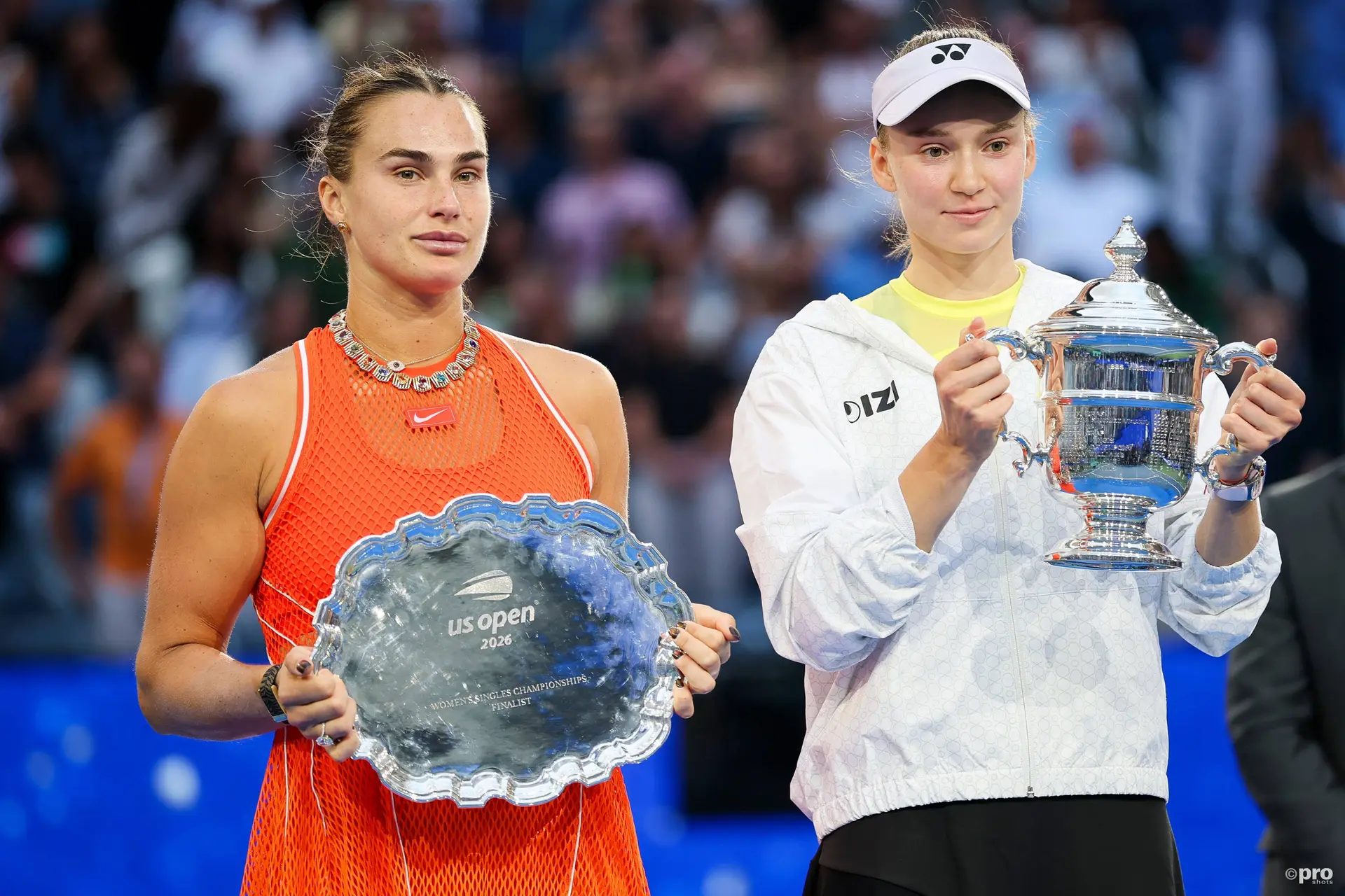 Elena Rybakina and Aryna Sabalenka holding trophies