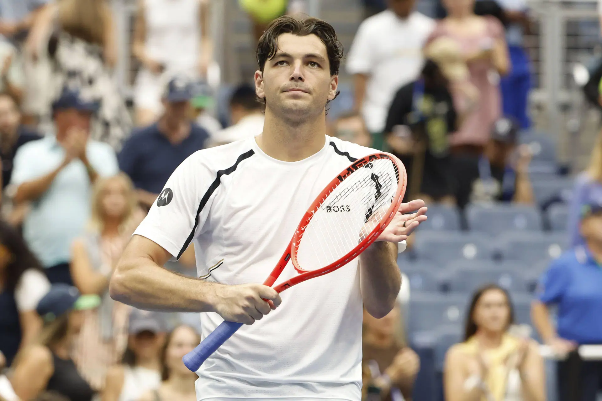 Taylor Fritz clapping with his racket