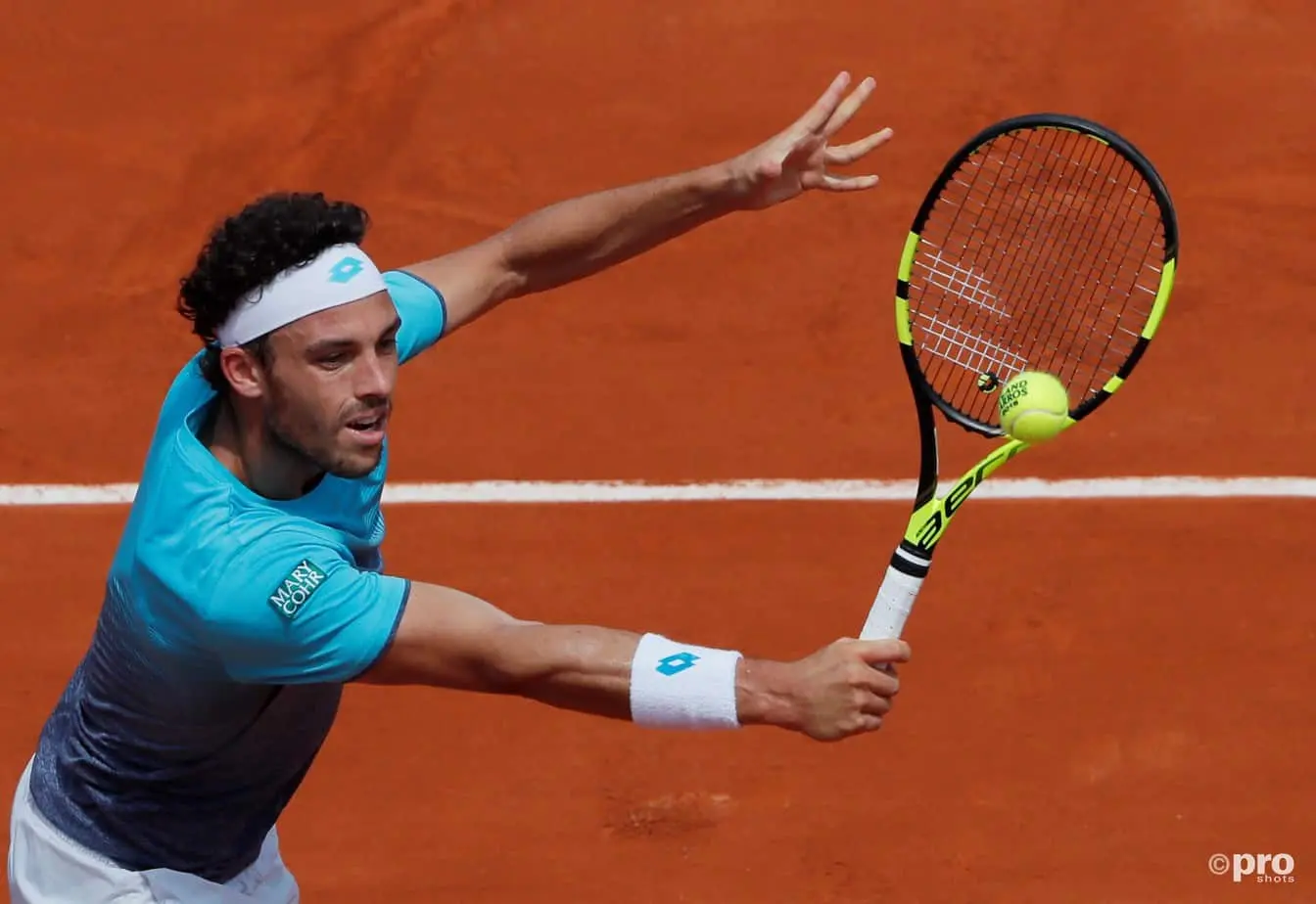 Marco Cecchinato hitting the ball with his racket at Roland Garros 2018