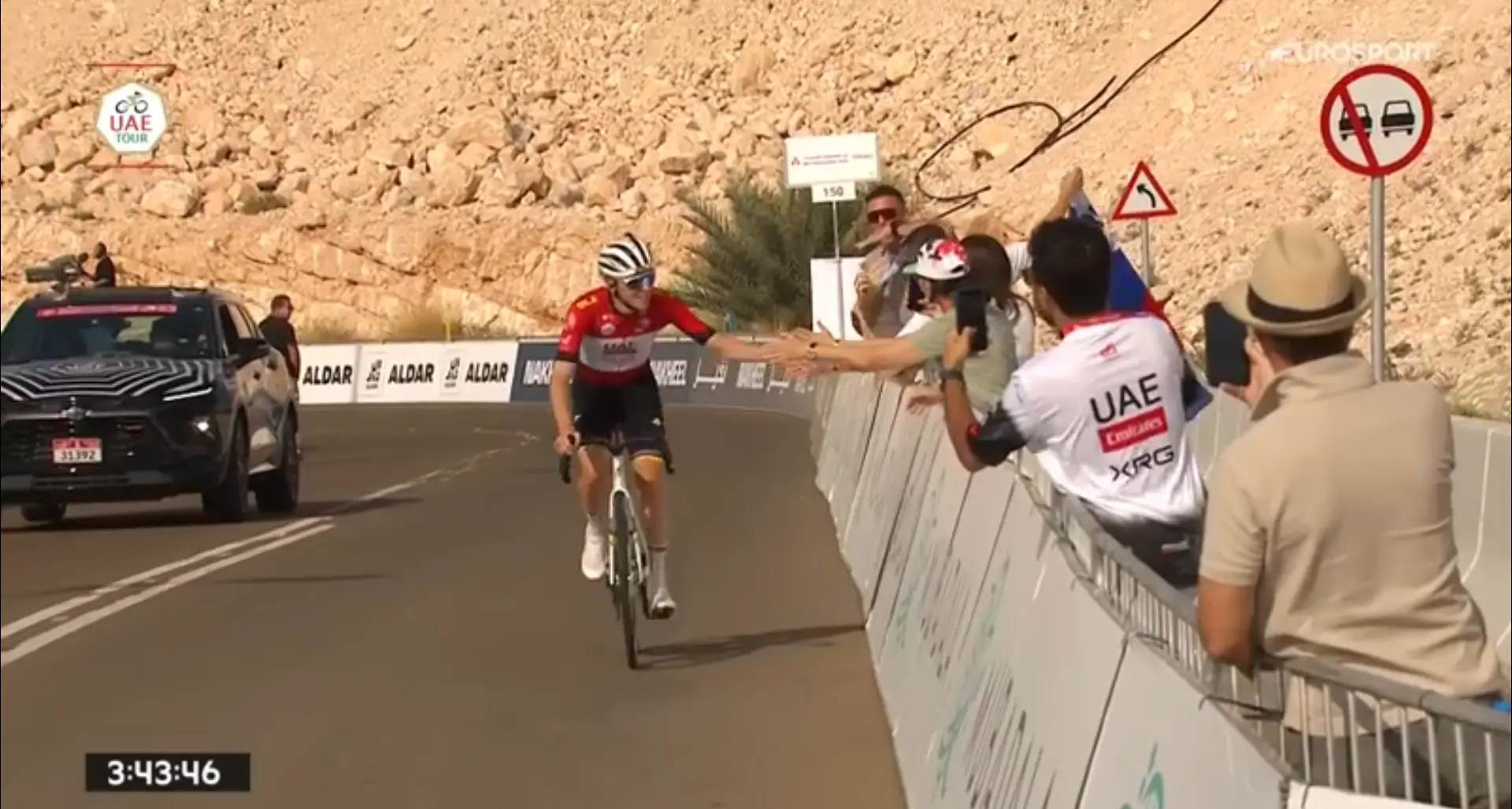Behind the smiling Pogacar finishing his training, two happy riders make their mark on the UAE podium