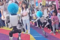 Chinese kungfu-robot met blauwe Pipo-pruik deelt per ongeluk kick uit aan klein bezoekertje