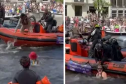 Amsterdam: Demonstranten springen in gracht tijdens Canal Gay Pride