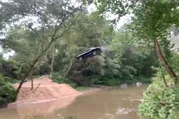 Stuntdude vliegt in een Dodge Challenger zo'n 30 meter over een rivier
