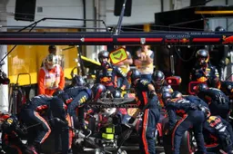 Pushed towards the car? A mechanic is hit in the pit lane