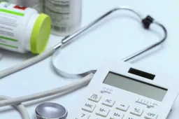 calculator-stethoscope-medicine-bottles-white-background