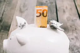 close-up-folded-fifty-euro-note-slot-white-piggybank