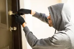 profile view man with hoodie trying pick lock house forcing his entry 1