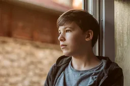 side-view-sad-boy-looking-outside