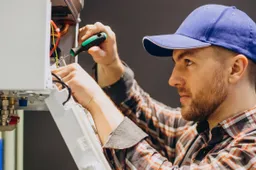 service-man-adjusting-house-heating-system