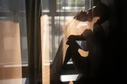 creative-portrait-man-with-curtains-shadows-from-window