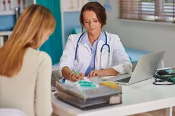 doctor-writing-prescription-her-patient