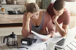worried-couple-reviewing-their-family-finances-calculating-expenses (1)