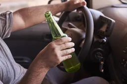 bottle-beer-man-s-hands-driving-car-daytime