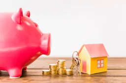 house-with-key-stacked-coins-besides-piggybank