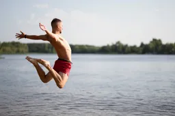 man-jumping-lake