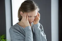 sick-woman-home-massaging-temples-feeling-strong-headache