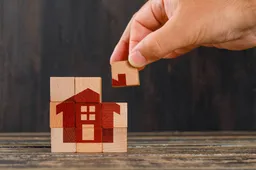 stay-home-concept-wooden-table-side-view-hand-holding-wooden-cube