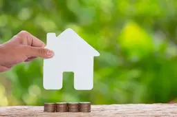 world-habitat-day-close-up-picture-pile-coins-andhand-holding-model-house
