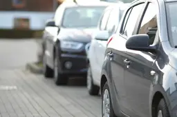 closeup-shot-black-car-parking-lot-with-blurred-background