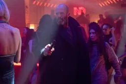 jason-statham-walks-through-a-crowd-with-a-little-girl-in-shelter