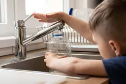 close-up-kid-filling-bottle-with-water