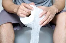 Mans-hands-holding-a-roll-of-toilet-paper