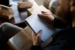 high-angle-man-holding-notebook
