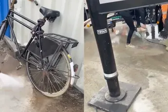 Fietser in Amsterdam rijdt door nat beton