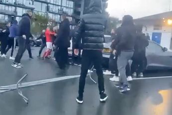 Gezelligheid op parkeerplaats na voetbalwedstrijd in Den Haag: Spelers en fans aan het knokken