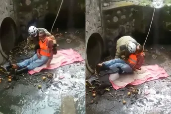 Hulpverlener redt iemand van de regen in de drup