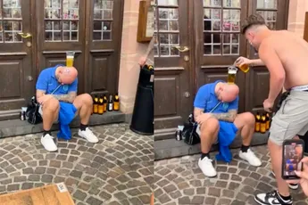 Engeland-supporters vermaken zich prima met een medelander die een glas op zijn hoofd heeft staan