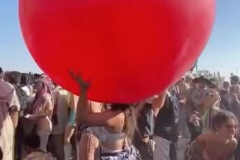 Dame geniet tijdens Burning Man van een ballonnetje