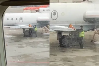 In Rusland halen ze blijkbaar het ijs van een vliegtuig met een verkeerskegel