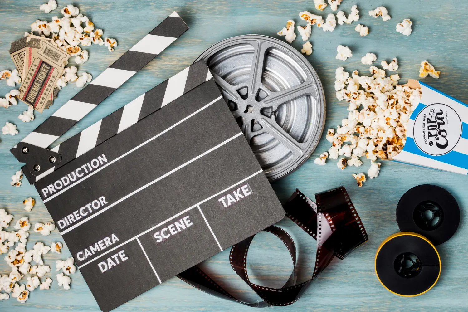 clapperboard popcorn film stripe cinema tickets wooden desk